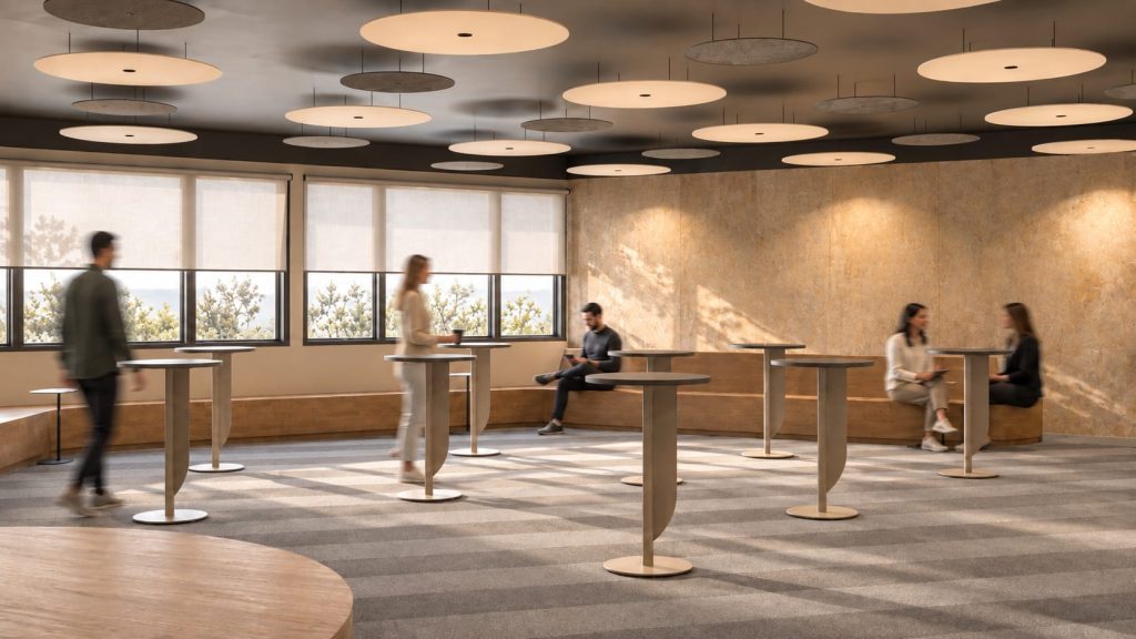Sala polivalente de un auditorio en Madrid (POL23): zona lounge con mesas altas, banco corrido y discos acústicos en el techo negro
